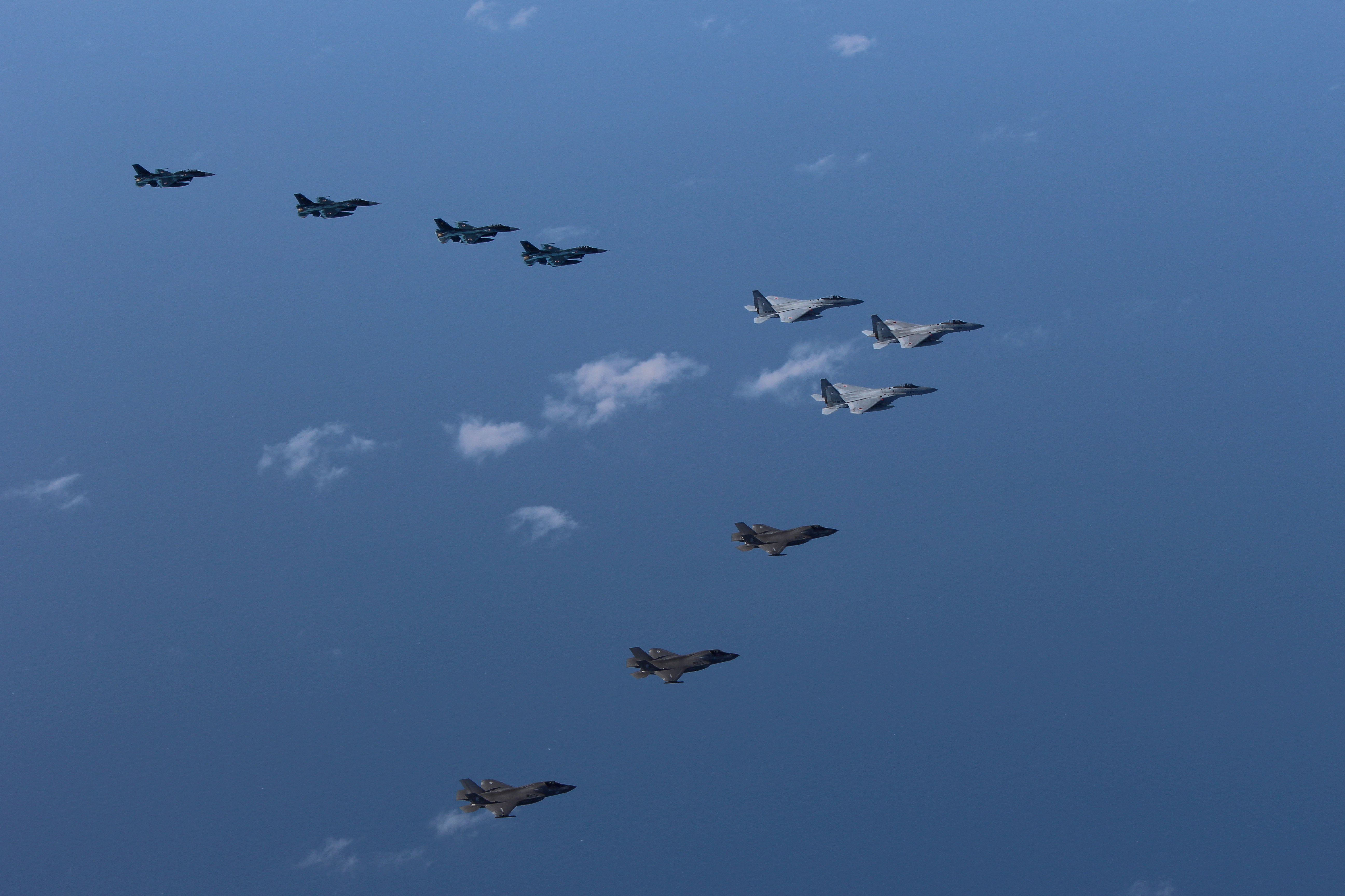 Japan Air Self-Defense Force's F-15 and F-2 fighters hold a joint military drill with U.S. Marine Aircraft Group's F-35B fighters off Japan's southernmost main island of Kyushu, Japan
