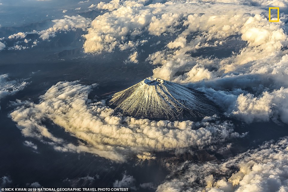 13005042-6985057-Mount_Fuji_in_Japan_is_seen_surrounded_by_clouds_in_a_dramatic_s-a-36_1556809698543.jpg
