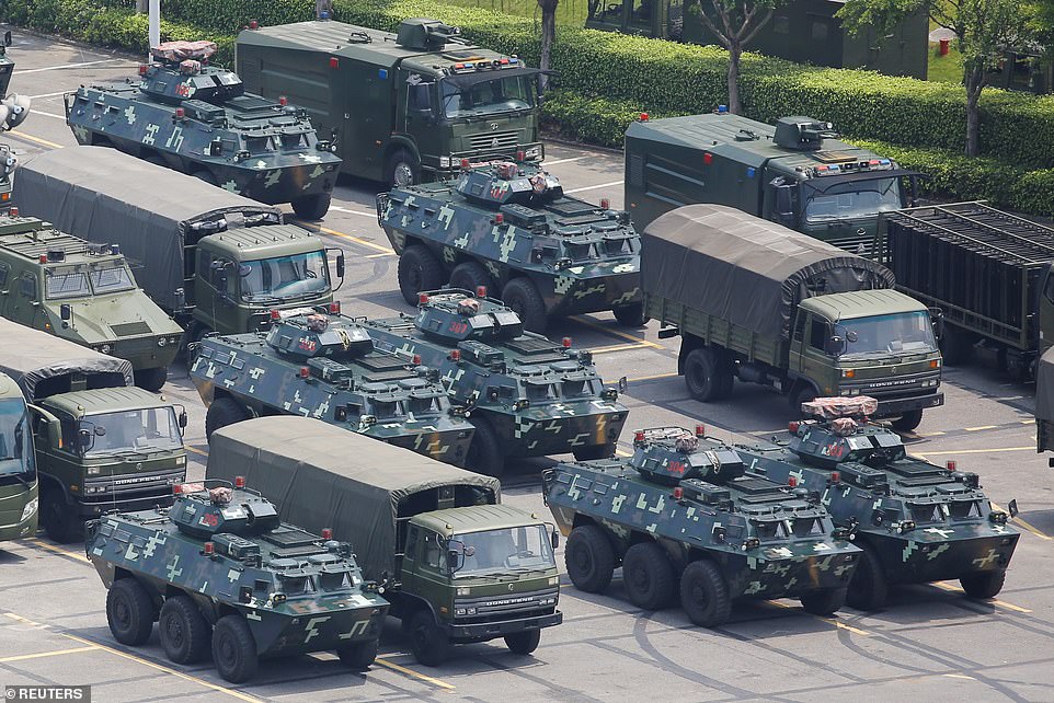 17303882-7359385-Military_vehicles_are_parked_on_the_grounds_of_the_Shenzhen_Bay_-a-118_1565864199777.jpg