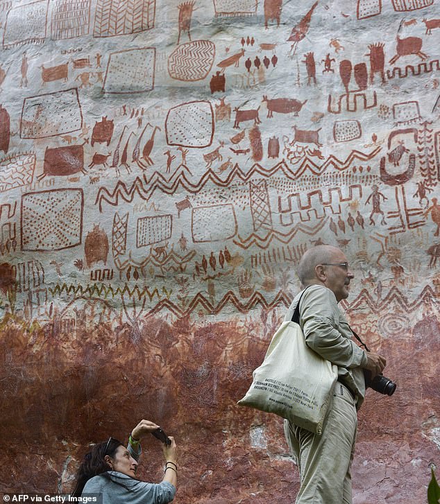 36232286-8998147-The_eight_mile_wall_of_prehistoric_rock_art_featuring_animals_an-a-7_1606669263482.jpg