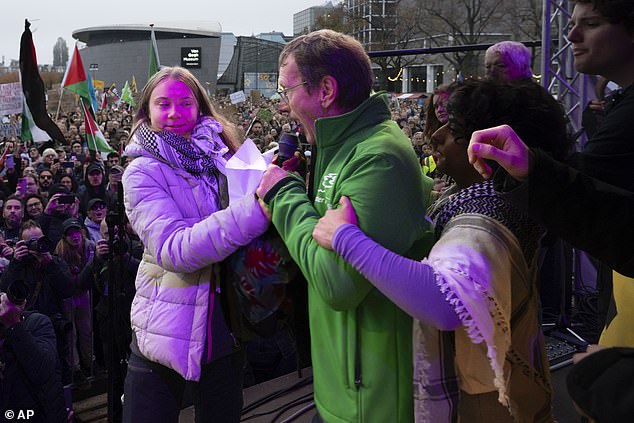 'I have come here for a climate demonstration, not a political view,' he said, before he was ushered off as crowd members booed