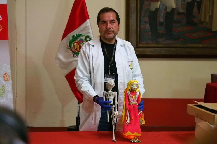 Flavio Estrada, from the Institute of Forensic Medicine shows off the supposed aliens found in Peru over the summer at a press conference on Jan. 12, 2024.