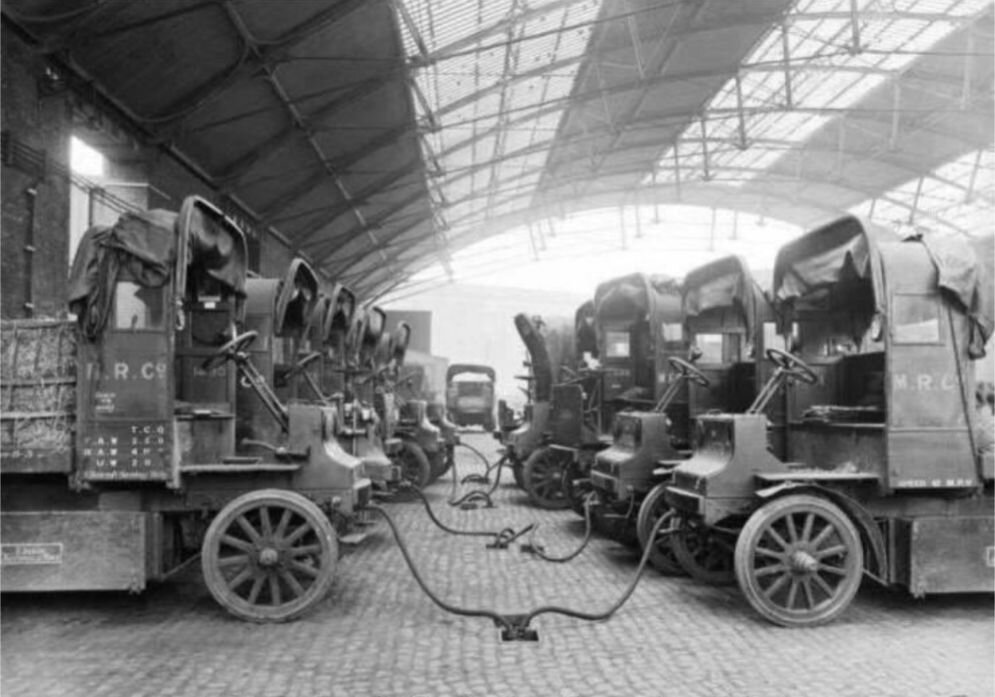 Electric trucks charging in Goods Depot, St Pancras Station, London 1917.jpg