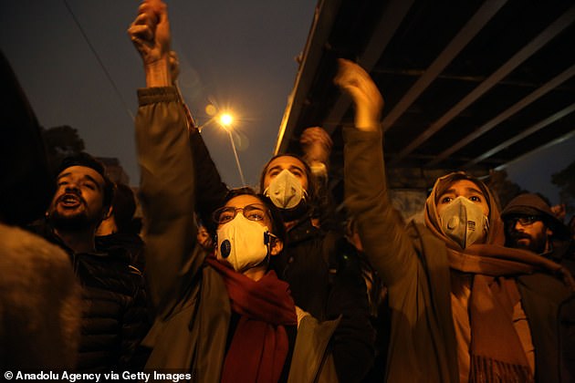 23301704-7879547-Iranians_shout_slogans_against_the_government_after_a_vigil_held-a-119_1578866004684.jpg