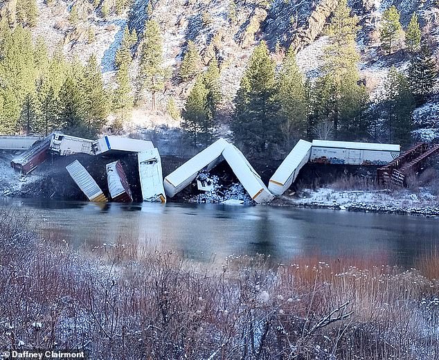 At least 25 cars on a train traveling through Montana derailed Sunday morning, spilling out contents into the area and a local body of water.