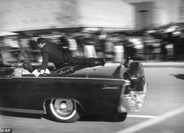 The limousine carrying mortally wounded JFK races toward the hospital seconds after he was shot in Dallas. Secret Service agent Clinton Hill is riding on the back of the car. Hill's right knee is near the crease in the top of the rear limo seat where Landis says he found the bullet
