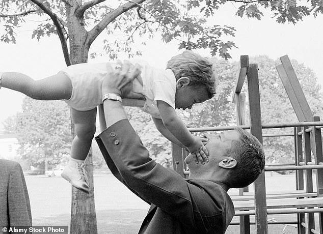 Secret Service agent Paul Landis, tasked with protecting JFK's kids and later his wife Jacqueline, lifts John F. Kennedy Jr into the air on the South Lawn of the White House