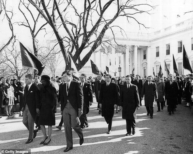 Robert and Edward Kennedy escort Jackie Kennedy from the White House to attend the funeral of President John F. Kennedy November 25, 1963, with Landis walking to the right rear