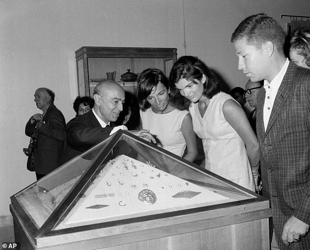 Landis (far right) is seen guarding Jacqueline Kennedy and her sister, Princess Lee Radziwill, as they view an exhibit in museum at Heraclion, Crete, Greece in October 1963
