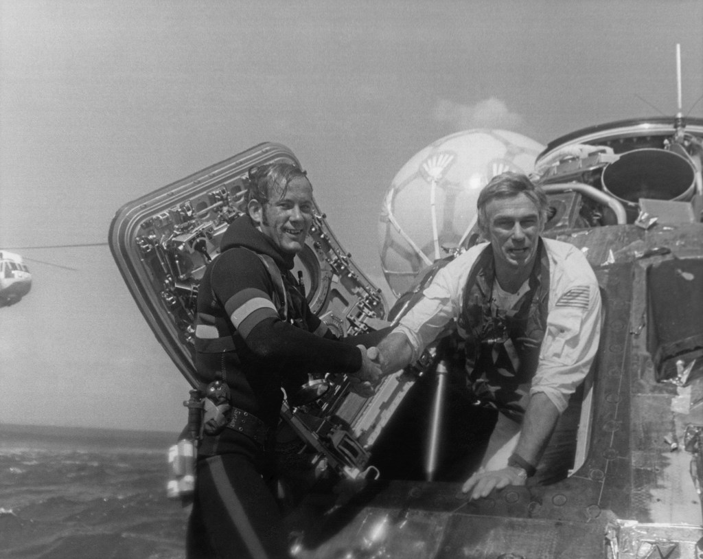 Cernan welcomed back to earth in the Pacific Ocean by Navy Pararescueman
