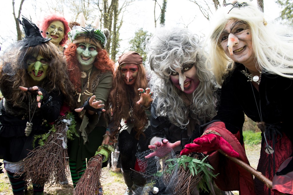 Women in a witch costumes pose during training for the 'Night of Nights in the Harz' in Wolfshagen, Germany, 24 April 2016.