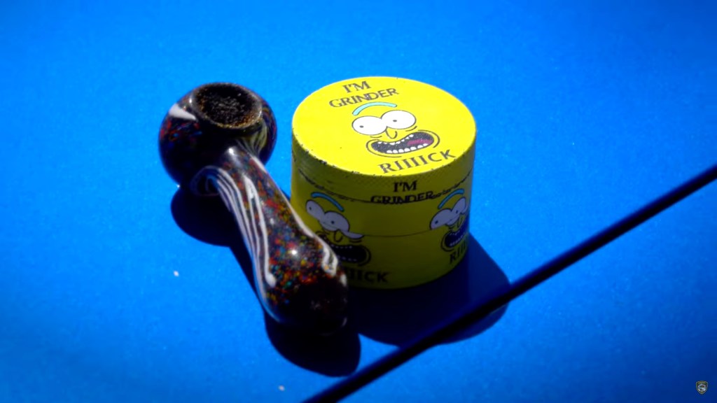 A photo of a marijuana pipe and a tin saying I'm grinder Riiiick seized from a driver.