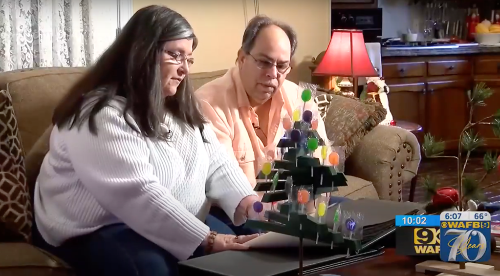 Kim Denicola and her husband sit as they look through old family photos, two months after she lost her memory in 2018