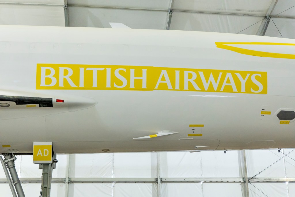 a large yellow Brith Airways stencil on the side of the Concorde